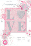 This anniversary card offers a tender portrait of enduring romance, its design blending soft pastel pinks and silvery greys, reminiscent of a gentle dusk sky over Kingston upon Thames. At the centre, the word LOVE is rendered in raised, velvety glitter, the letters subtle yet eye-catching. The O is replaced by a shimmering heart, textured in silver so that it seems to gleam when turned in the light, echoing the glint of water on the Thames. Around this heart-filled word, delicate blossoms unfold in blush, mauve, and creamy white. Their petals are drawn with a watercolour softness, edges gently blurred while fine lines pick out detail, much like the layered textures in a romantic bouquet arranged for delivery to homes near Hampton Wick or along Richmond Road. Slender vines and swirling tendrils weave between the flowers, while tiny decorative elements-floating petals, soft curls, and subtle butterflies-give the impression of motion, as if a light spring breeze is passing through. The background is a wash of pale pink and cool grey, creating a feeling of intimacy and quiet celebration. Elegant script across the top reads On Our Anniversary, with the heartfelt phrase I love you today and always placed near the centre or lower section. The lettering is slim, fluid, and refined, echoing the curves of the florals. Together, the thoughtful typography, shimmering heart, and pastel blooms create an image that feels both personal and timeless-an ideal keepsake for marking a shared journey in Kingston upon Thames, soft-spoken but deeply sincere.